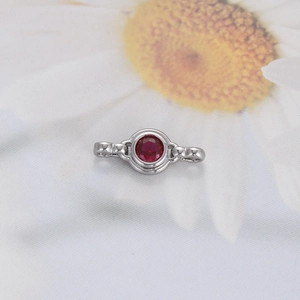 Close-up of silver metal connector with round red gemstone for DIY jewelry making