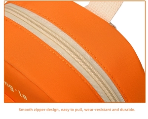 Detailed close-up of smooth zipper design and stitching on the orange kids backpack