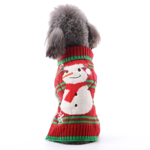Detail of red and green knitted pet Christmas sweater featuring white snowman pattern