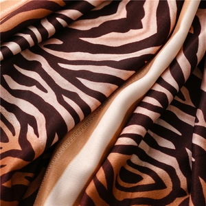 Detailed macro view showing the brown zebra print pattern and silky texture of the fabric