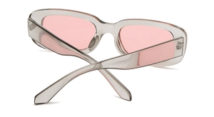 Detail view of transparent grey sunglasses frame and pink lenses with 45-degree angle