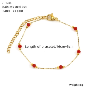 Detailed view of gold 304 stainless steel bracelet with red faceted glass beads
