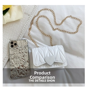 Detailed view of mini white heart-shaped quilted bag with gold chain and phone size comparison