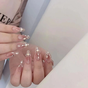 Handmade gradient pink press-on nails with pearls, rhinestones, and silver almond shape