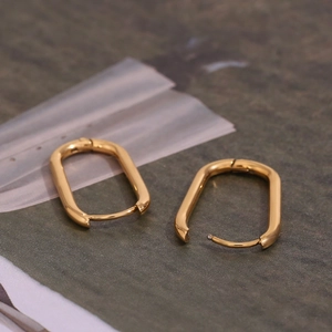 Detailed macro view of 18K gold plated stainless steel U-shaped hoop earrings