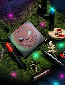 Detailed Halloween face and body paint set with colorful sticks in a spooky mossy setting