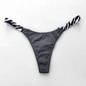 Detail view of cotton thong with zebra print elastic waistband and dark gray fabric