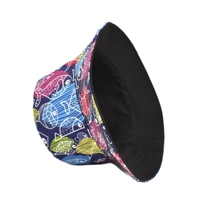 Detail of reversible bucket hat showing colorful cartoon fish print and black inner side
