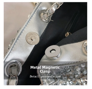 Close-up of silver sequin bucket bag featuring a magnetic metal snap and chain strap