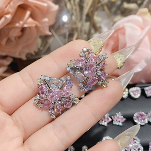 Close-up of star-shaped earrings with pink sapphire and multi-color zircon stones