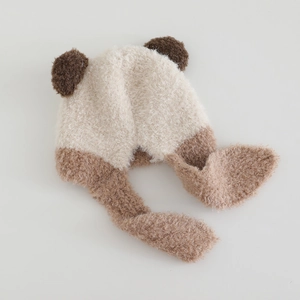 Detailed texture of plush fleece teddy bear hat with thick cream faux fur fabric