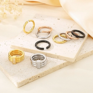 Detailed collection of 18k gold plated titanium rings with enamel and diamonds on stone