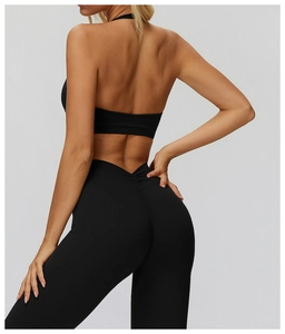 Detail of high-waist yoga leggings with V-cut waistline and racerback sports bra in black