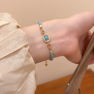 Detailed shot of vintage beaded bracelet with turquoise stone and pearls on wrist