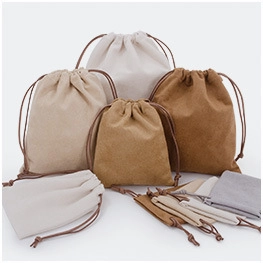 Variety of cotton drawstring bags in multiple sizes and neutral colors for packaging