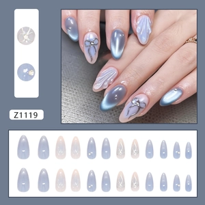 Blue cat-eye press-on nails with 3D embossed flowers and silver bow rhinestones