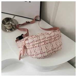 Close-up of pink tweed crossbody bag with adjustable strap and metal hardware details