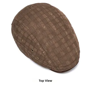Top view of vintage brown plaid flat cap with side metal eyelets on white background