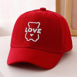 Detail of red cotton baseball cap with white bear embroidery and LOVE text for kids