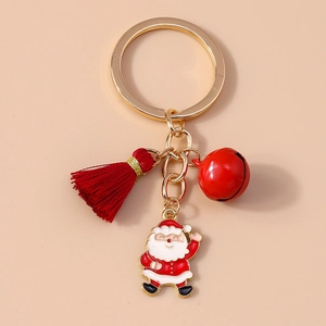 Close-up of Christmas keychain with Santa Claus charm, red bell and tassel detail