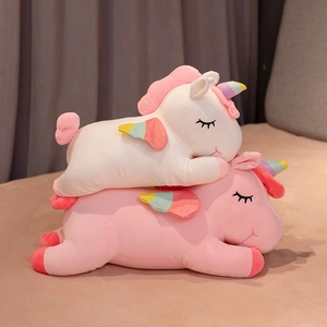 Lying rainbow unicorn plush toys in pink and white with soft wings and embroidery