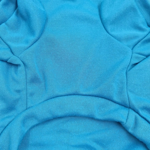 Detail of light blue dog vest showing premium double-stitched seams and knit fabric texture