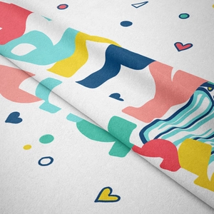 Close-up of soft bohemian printed fabric showing heart shapes and vibrant geometric patterns