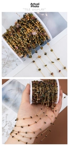 Detail of colorful natural stone bead chain with gold wire wrap for DIY jewelry making