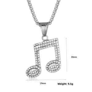 Close-up of music note pendant with crystal pavé and 34mm by 29mm size dimensions