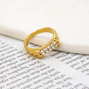 Macro shot of 18K gold plated ring with two rows of cubic zirconia on a book