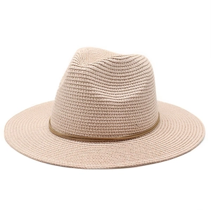 Close-up of woven straw sun hat texture with decorative dark brown leather cord detail