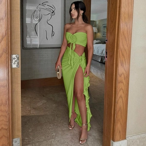 Detail of lime green strapless tube top with 3D flower and side slit maxi skirt