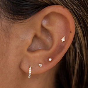 Detailed view of model wearing gold S925 silver geometric earrings set with white zircon