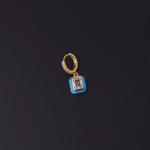Detailed shot of golden enamel hoop earring with blue rectangular pendant and clear zircon