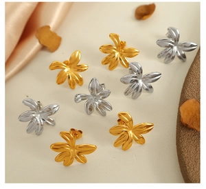 Detailed view of floral titanium steel earrings in gold and silver plating with petals