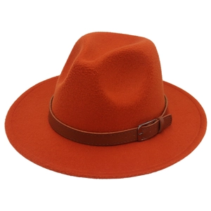 Close-up of orange wool felt fedora featuring a brown leather band and silver metal buckle