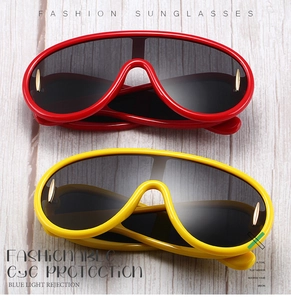 Detail view of red and yellow oversized sunglasses with blue light rejection feature