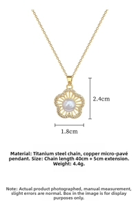 Macro detail of gold flower pendant with micro-set zircons and a white pearl