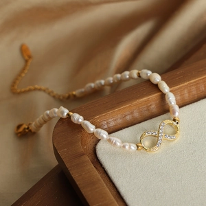 Natural freshwater pearl bracelet with infinity pendant in 18k gold plated finish