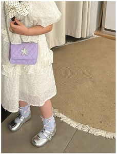 Kid's quilted crossbody bag with star decor paired with white puffed sleeve dress