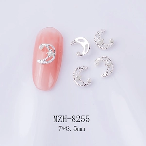 Detailed view of silver moon nail charms with white pearls, size 7x8.5mm macro shot