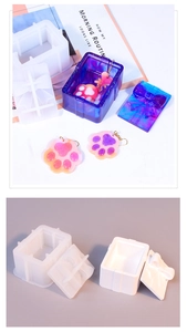 Macro shot of silicone molds for resin gift box with bow lid and cat paw earrings