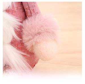 Detailed view of pink sequin fabric and soft white faux fur texture on gnome plush
