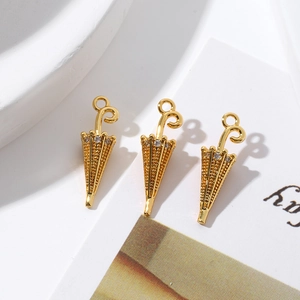 Detailed view of three 18K gold-plated umbrella pendants with sparkling zircon stones