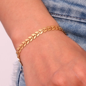 Detail of a 18K gold plated stainless steel leaf bracelet worn on the wrist