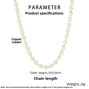 Detail of golden heart-shaped copper chain necklace with white enamel inlay accents