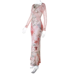 Detail of pink floral dress featuring deep V-neck and delicate lace cuffs on long sleeves