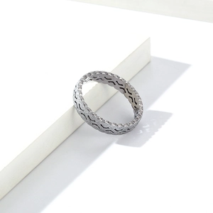Close-up of silver ring with elegant wavy texture and matte finish detailing