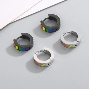 Close-up of rainbow striped stainless steel hoop earrings in black and silver finishes