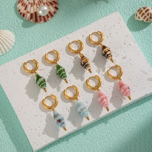 Detailed view of colorful ceramic conch shell earrings in gold and ocean hues